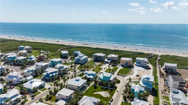 drone / aerial view with a water view and a beach view