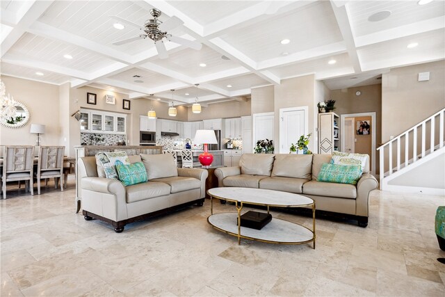 living room featuring a towering ceiling, beam ceiling, and coffered ceiling