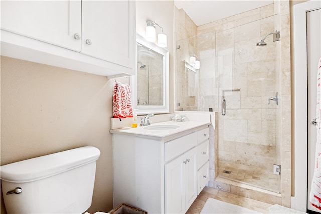 bathroom with an enclosed shower, vanity, tile patterned floors, and toilet