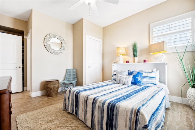 bedroom with light wood-type flooring and ceiling fan