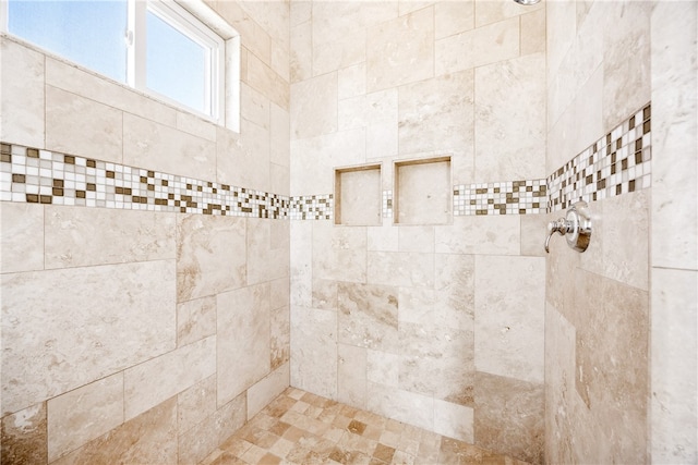 interior details with a tile shower