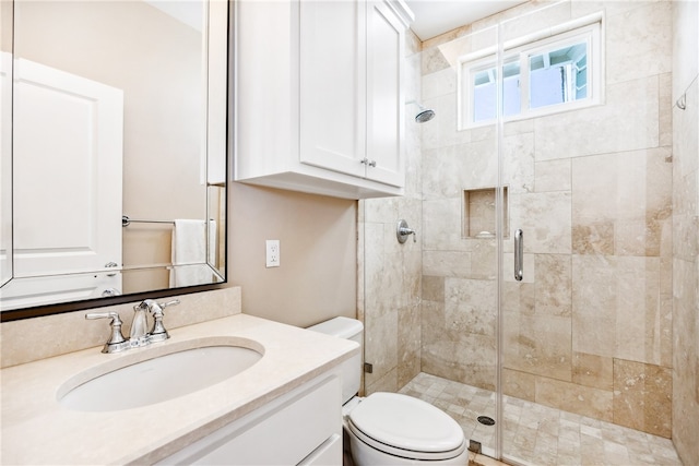 bathroom featuring an enclosed shower, vanity, and toilet