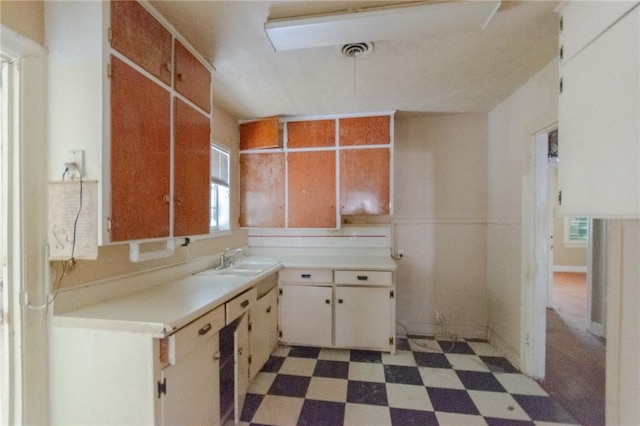 kitchen featuring sink and white cabinets