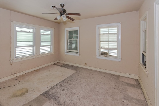 empty room featuring ceiling fan and a wealth of natural light