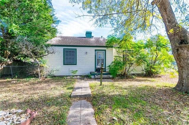 bungalow-style home with a front yard