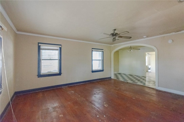 unfurnished room featuring ceiling fan, crown molding, and dark wood-type flooring