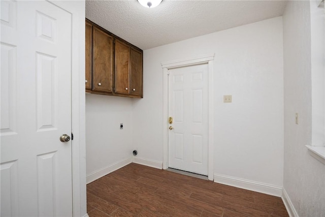 laundry area with cabinets, electric dryer hookup, dark hardwood / wood-style flooring, and a textured ceiling