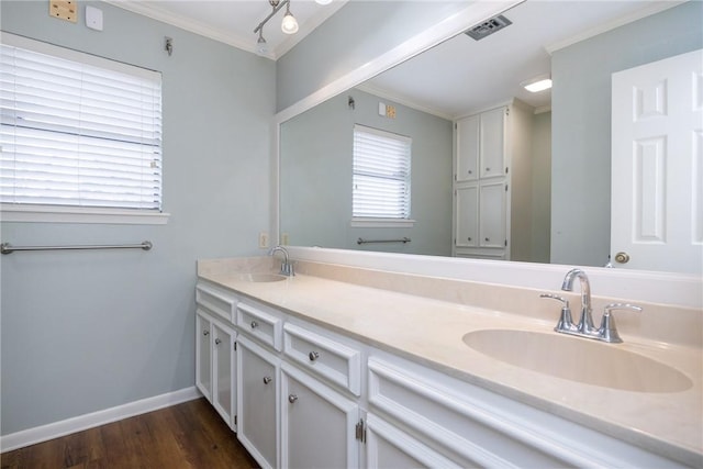 bathroom with vanity, hardwood / wood-style flooring, and ornamental molding