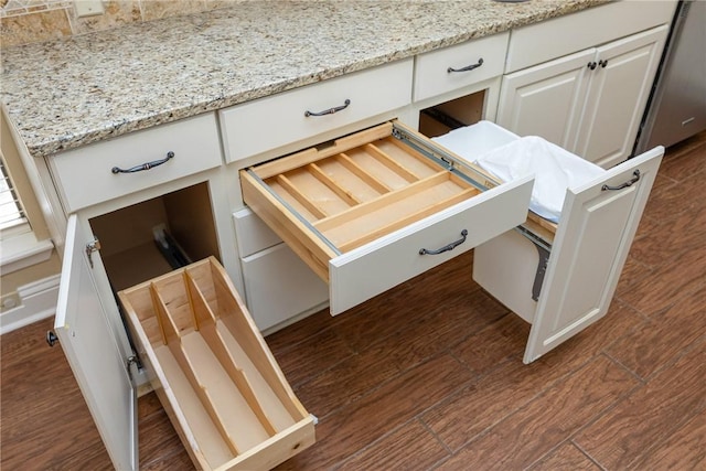 kitchen featuring white cabinetry and light stone counters