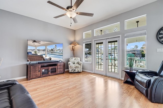 sitting room featuring ceiling fan, french doors, a wealth of natural light, and light hardwood / wood-style flooring