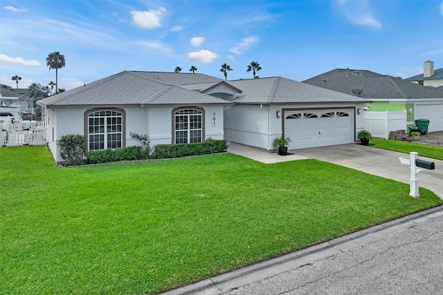 ranch-style home with a front yard and a garage