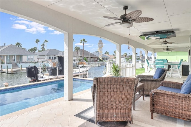 view of pool featuring a patio area and a water view