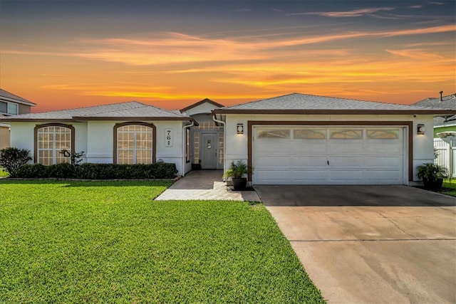 view of front facade featuring a lawn and a garage