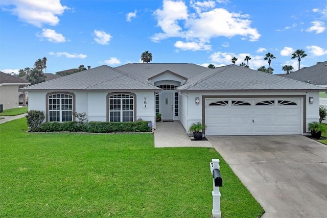 ranch-style home featuring a garage and a front lawn