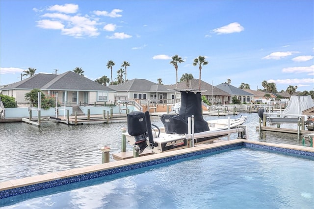 view of pool featuring a boat dock and a water view