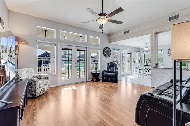 living room with french doors, ceiling fan, and hardwood / wood-style floors