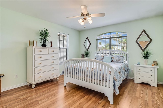 bedroom with ceiling fan and light wood-type flooring