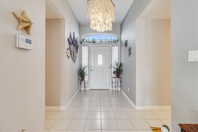 tiled entryway featuring an inviting chandelier