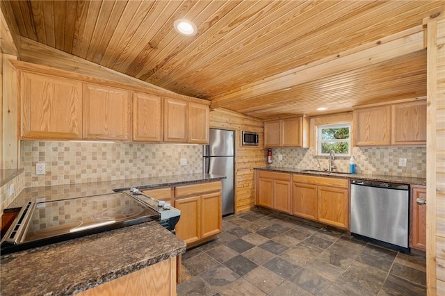 kitchen with vaulted ceiling, sink, appliances with stainless steel finishes, wood ceiling, and dark stone counters