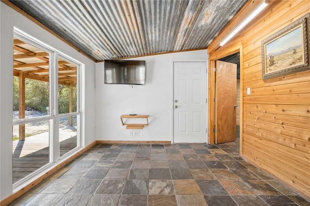 entryway featuring wooden walls