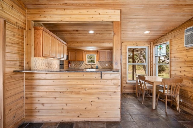 kitchen with a healthy amount of sunlight, kitchen peninsula, and wooden ceiling