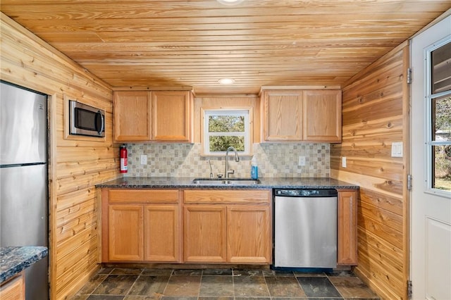 kitchen featuring wood ceiling, appliances with stainless steel finishes, sink, and dark stone counters