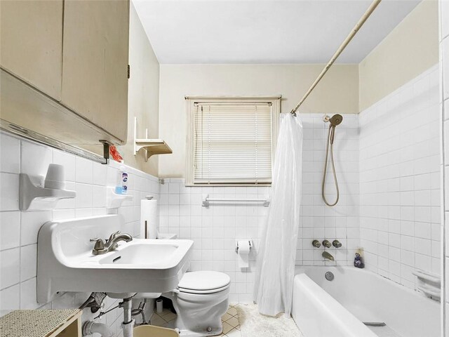 3434 Kay St, Corpus Christi, TX 78411 - bathroom with shower / tub combo with curtain, toilet, tile walls, tile patterned floors, and wainscoting