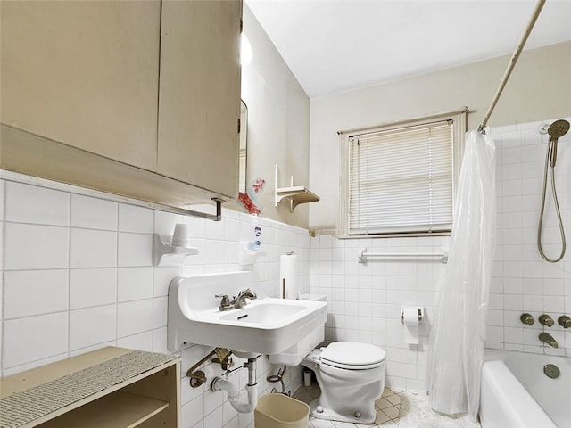 bathroom with tile patterned flooring, shower / bath combo, toilet, and tile walls