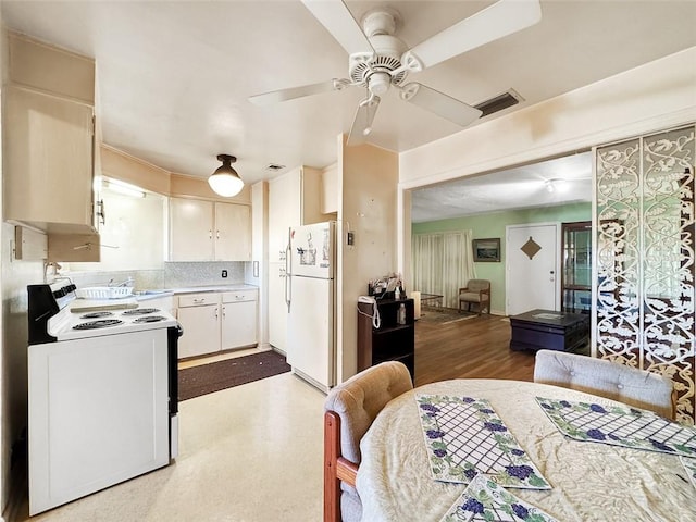 kitchen with white cabinetry, ceiling fan, tasteful backsplash, hardwood / wood-style floors, and white appliances