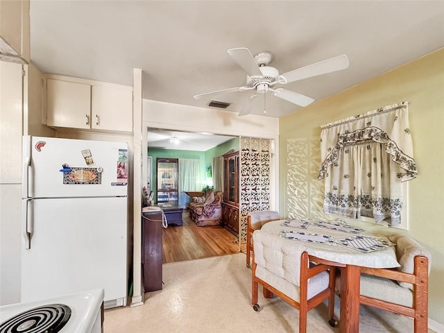 dining space with ceiling fan and light hardwood / wood-style floors