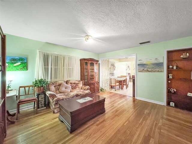 3434 Kay St, Corpus Christi, TX 78411 - living area featuring wood finished floors, baseboards, and a textured ceiling