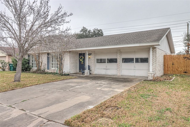 single story home with a garage and a front lawn