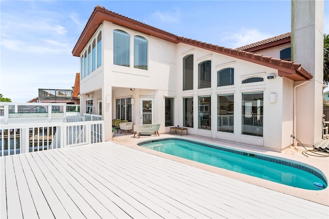 13726 Cayo Gorda Ct, Corpus Christi, TX 78418 - back of property featuring a deck, stucco siding, and an outdoor pool