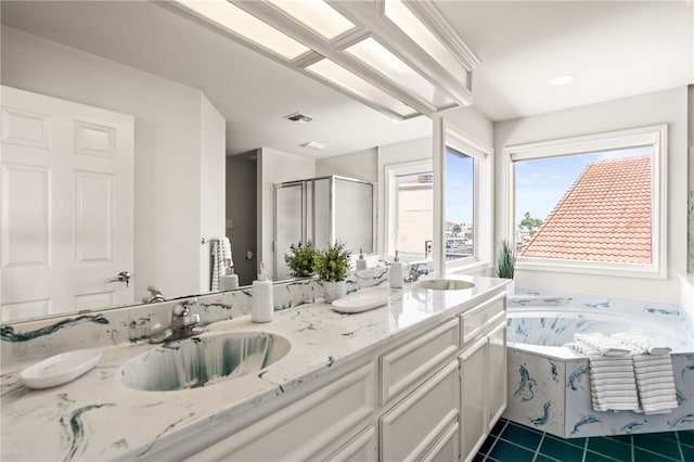 13726 Cayo Gorda Ct, Corpus Christi, TX 78418 - bathroom featuring a sink, visible vents, a shower stall, double vanity, and a garden tub