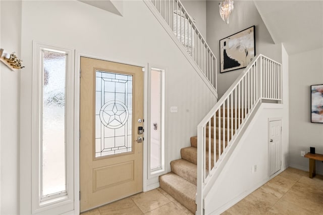 13726 Cayo Gorda Ct, Corpus Christi, TX 78418 - foyer entrance with tile patterned flooring, stairs, a high ceiling, and a notable chandelier