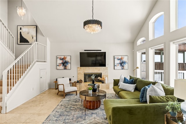 13726 Cayo Gorda Ct, Corpus Christi, TX 78418 - living area with stairs, a high end fireplace, high vaulted ceiling, an inviting chandelier, and light tile patterned floors