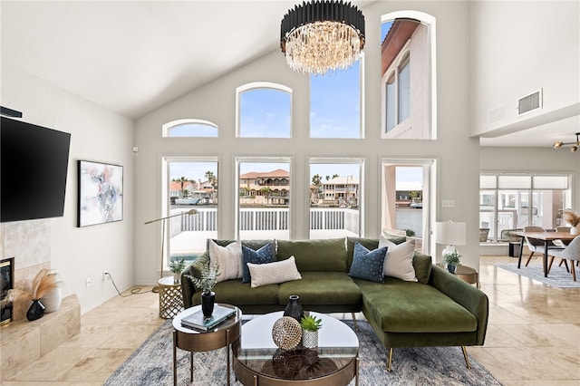 13726 Cayo Gorda Ct, Corpus Christi, TX 78418 - living room featuring a chandelier, high vaulted ceiling, visible vents, and a tile fireplace