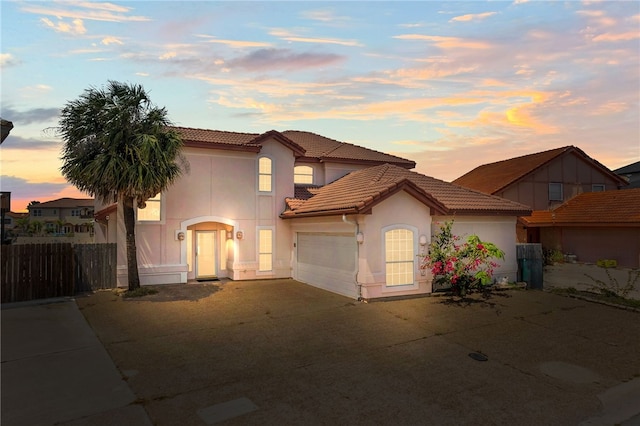 13726 Cayo Gorda Ct, Corpus Christi, TX 78418 - mediterranean / spanish-style house with driveway, fence, a garage, stucco siding, and a tile roof