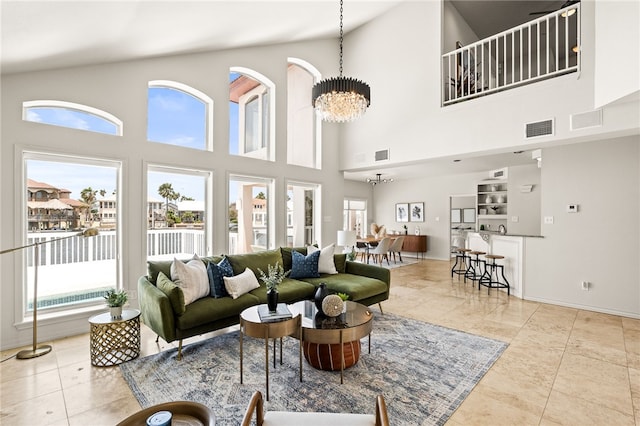 13726 Cayo Gorda Ct, Corpus Christi, TX 78418 - tiled living room with an inviting chandelier, a towering ceiling, a healthy amount of sunlight, and visible vents