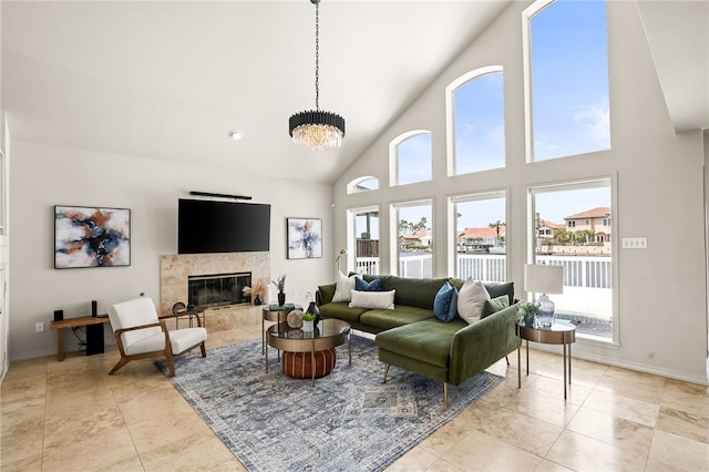 13726 Cayo Gorda Ct, Corpus Christi, TX 78418 - living area featuring baseboards, an inviting chandelier, light tile patterned flooring, high vaulted ceiling, and a fireplace