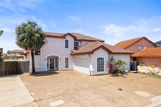 13726 Cayo Gorda Ct, Corpus Christi, TX 78418 - mediterranean / spanish house featuring an attached garage, stucco siding, a tile roof, fence, and concrete driveway