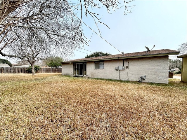 rear view of property featuring a yard