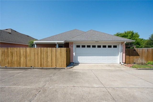 2301 Cyprus Dr, Ingleside, TX 78362 - ranch-style home with concrete driveway, an attached garage, stucco siding, and roof with shingles