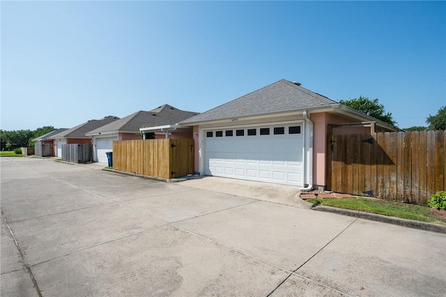 2301 Cyprus Dr, Ingleside, TX 78362 - view of front facade with driveway, a shingled roof, and a garage
