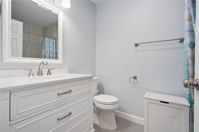 2301 Cyprus Dr, Ingleside, TX 78362 - bathroom with vanity, baseboards, toilet, and curtained shower