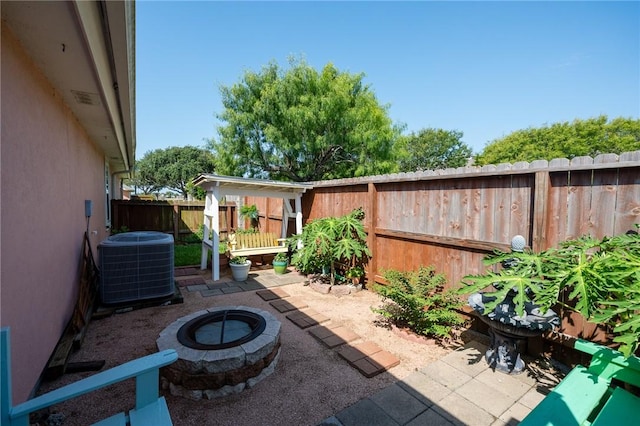 2301 Cyprus Dr, Ingleside, TX 78362 - fenced backyard with an outdoor fire pit, central AC unit, and a patio