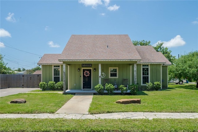 bungalow featuring a front lawn and a porch