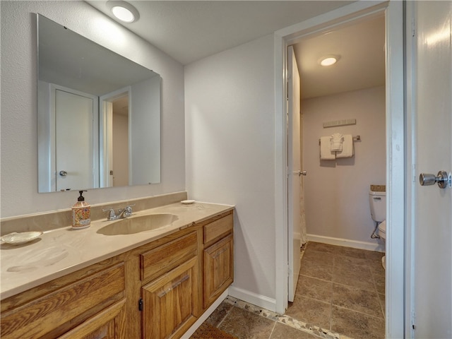 bathroom with vanity and toilet