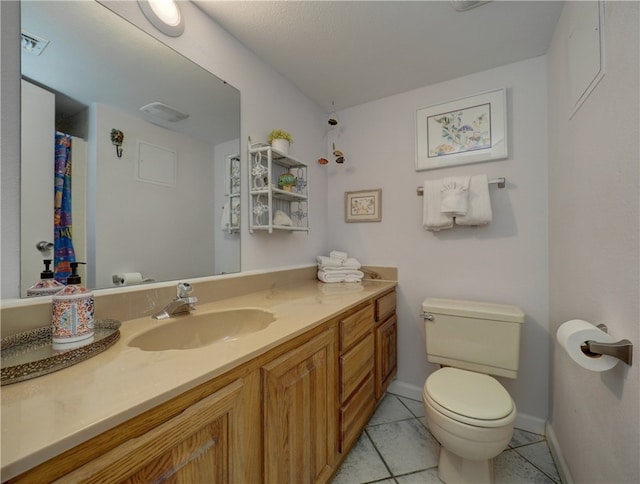 bathroom featuring vanity, tile patterned floors, and toilet