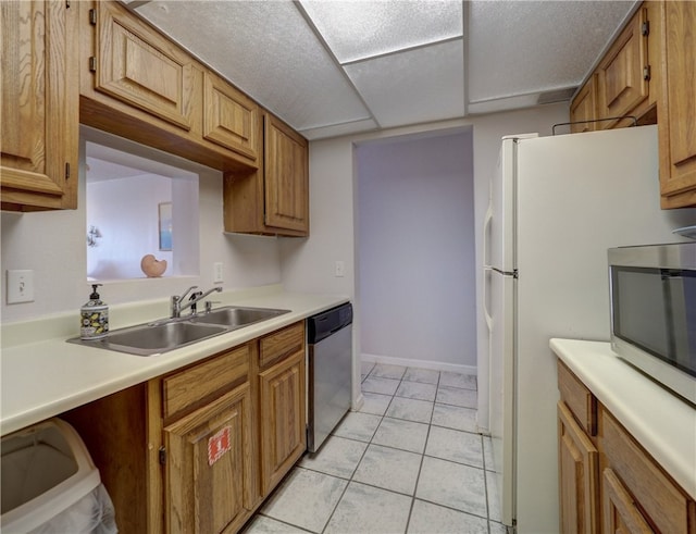 kitchen featuring light tile patterned floors, sink, and appliances with stainless steel finishes